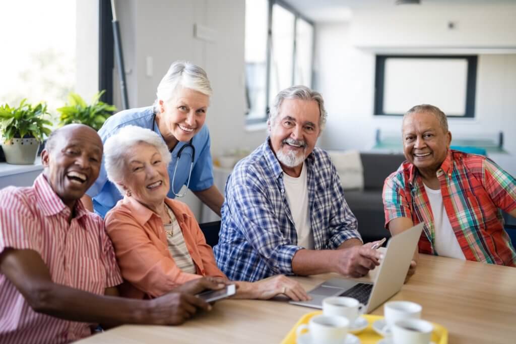 Portrait of smiling practitioner with senior people