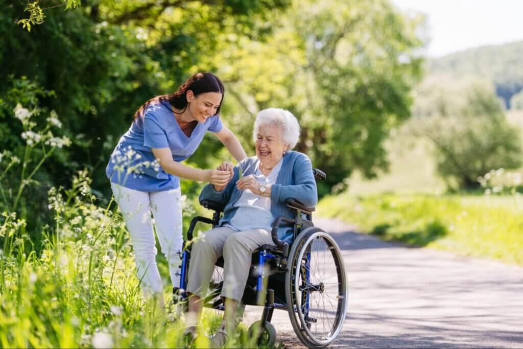 Senior resident in a serene outdoor garden at a luxury senior living facility in West Tarzana.
