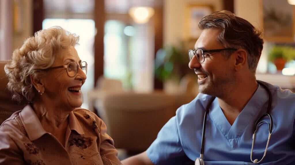 Senior resident and male doctor enjoying a happy conversation in a Royal Garden Board and Care home.