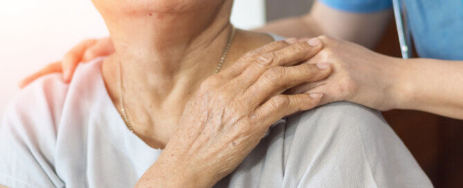 put focus keyword 13:21 A caregiver gently rests a hand on an older woman's shoulder while evaluating memory care services for a loved one.